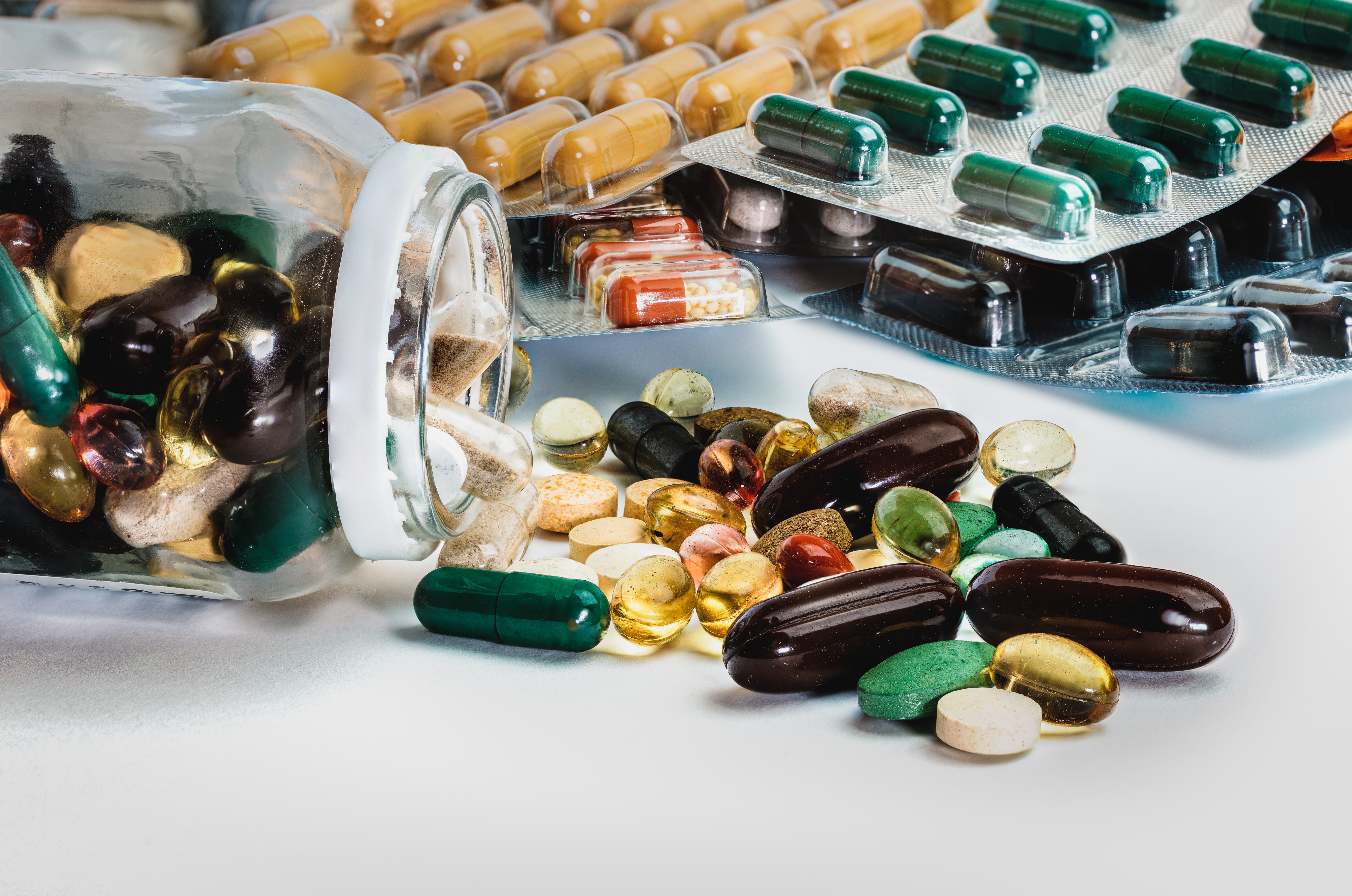 Many pills on white background
