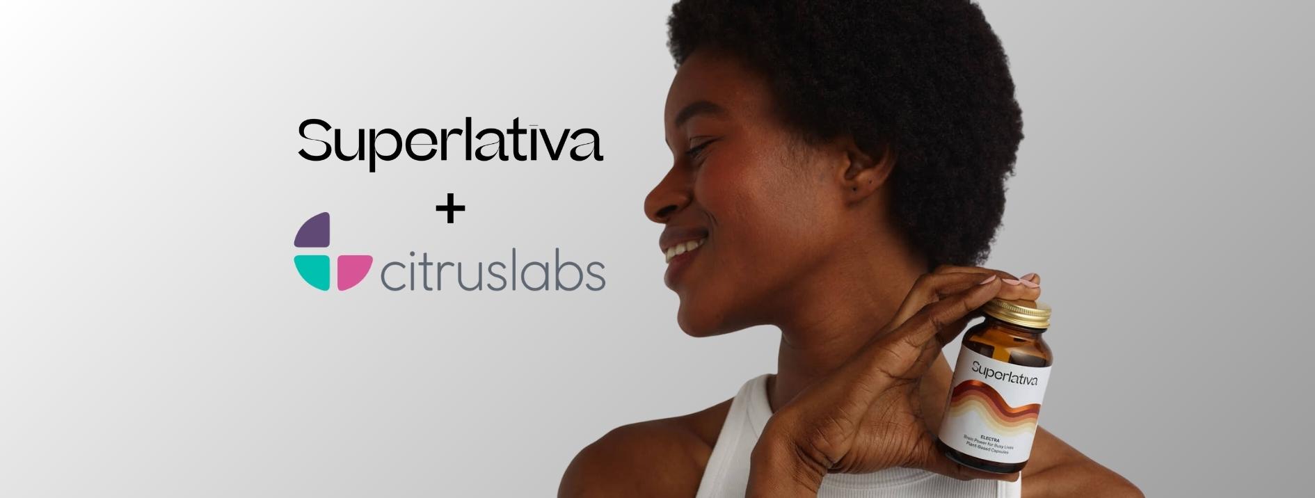 A woman holding a bottle of Superlativa's Electra supplement. Text logo of Superlativa and Citruslabs